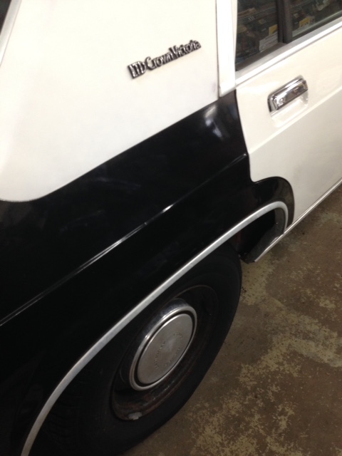 1988 Ford Crown Victoria LTD - Close-up of the side of a 1988 Ford Crown Victoria LTD, showing the two-tone paint scheme and chrome accents.