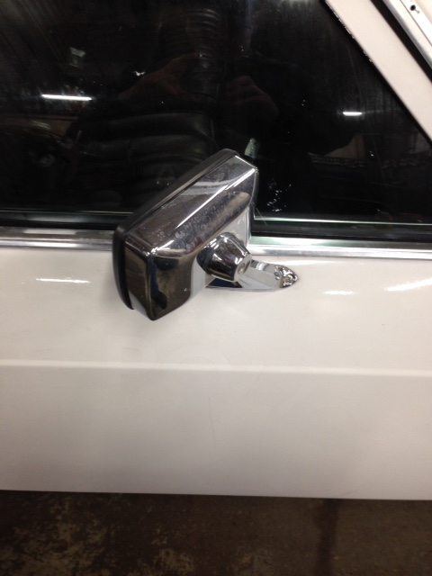 1988 Ford Crown Victoria LTD - Close-up of a chrome side mirror on a white vehicle door.