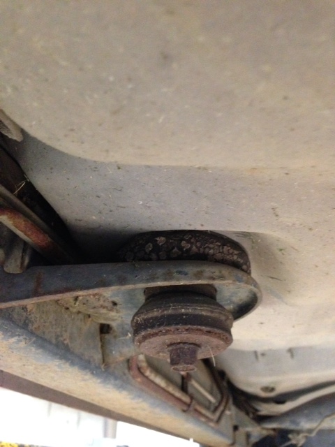 1988 Ford Crown Victoria LTD - Close-up view of the undercarriage of a vehicle, highlighting aged suspension parts.