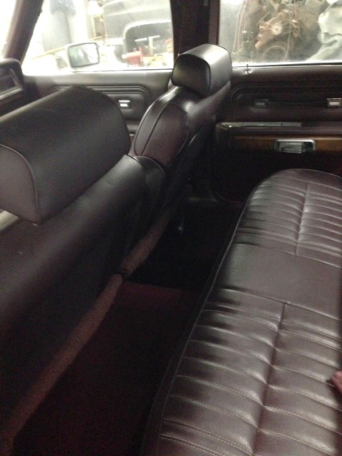 1988 Ford Crown Victoria LTD - Interior view of a car showing the rear seats and door panel.