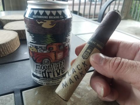 2018 Ford Bronco - A beer can and a cigar are placed on a table, with a hand holding the cigar.