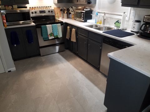 2018 Ford Bronco - A view of a kitchen dark cabinetry, a stainless steel stove and microwave, and a double sink area.