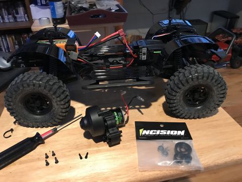 1989 Ford Bronco - RC car chassis and parts laid out on a table, ready for assembly or repair.