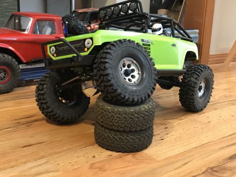 1989 Ford Bronco - RC rock crawler with stacked tires and another RC vehicle in the background.
