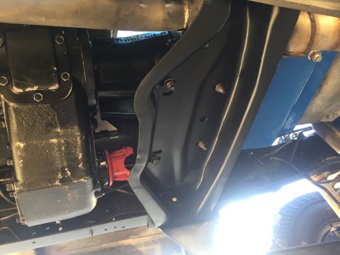1978 Ford Bronco - Underside view shows transmission, exhaust, and a red distributor cap.