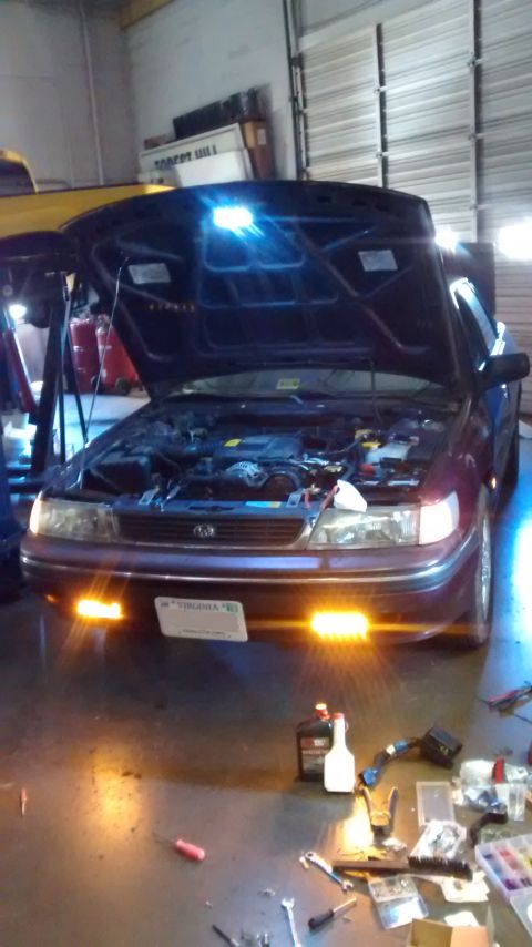 1994 Subaru Legacy - Front view of a 1994 Subaru Legacy with the hood open, revealing the engine compartment.