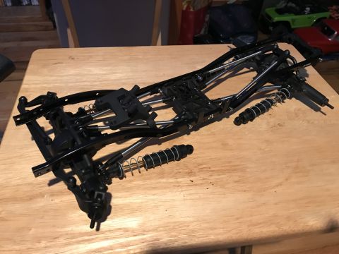 1989 Ford Bronco - RC car chassis assembly with suspension parts and springs visible.