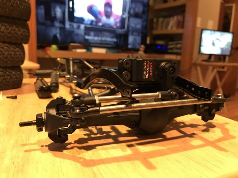 1989 Ford Bronco - Close-up of an RC car chassis assembly, a Tactic servo motor with metal gears.
