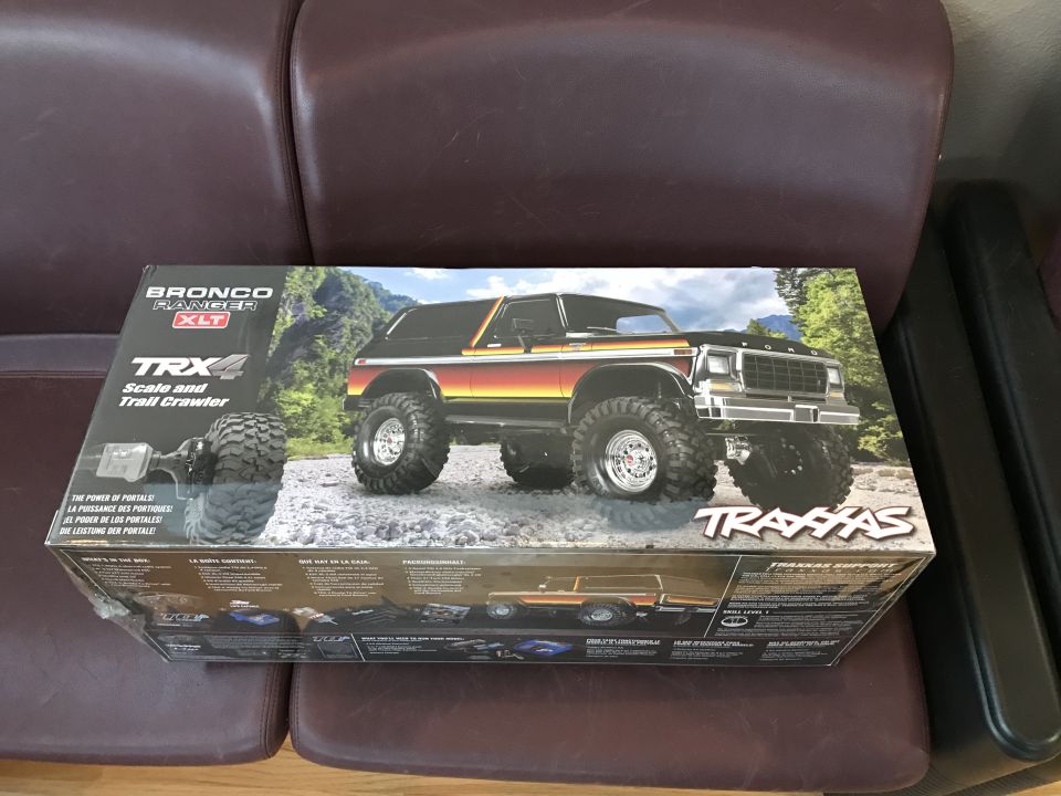 Box for Traxxas TRX4 Bronco Ranger XLT scale and trail crawler on a leather couch.