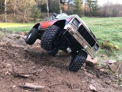 1989 Ford Bronco - Remote control rock crawler truck navigating an outdoor obstacle course.