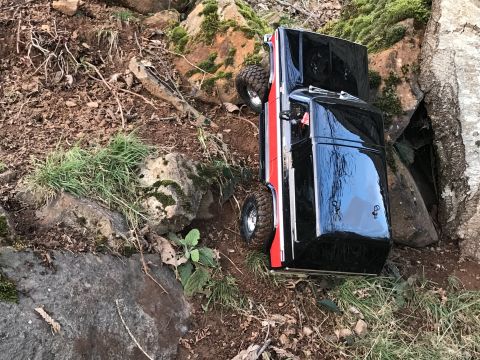 1989 Ford Bronco - A remote-controlled truck navigates a challenging, rocky outdoor course.