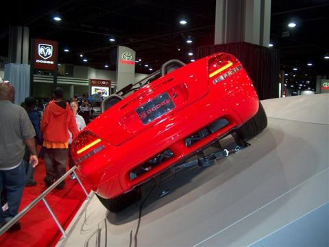2001 Ford Crown Victoria - Red Dodge convertible displayed at an auto show with Dodge and Toyota branding visible in the background.