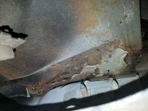 1994 Ford Bronco - Photograph of rust damage on a body panel, not a technical document.