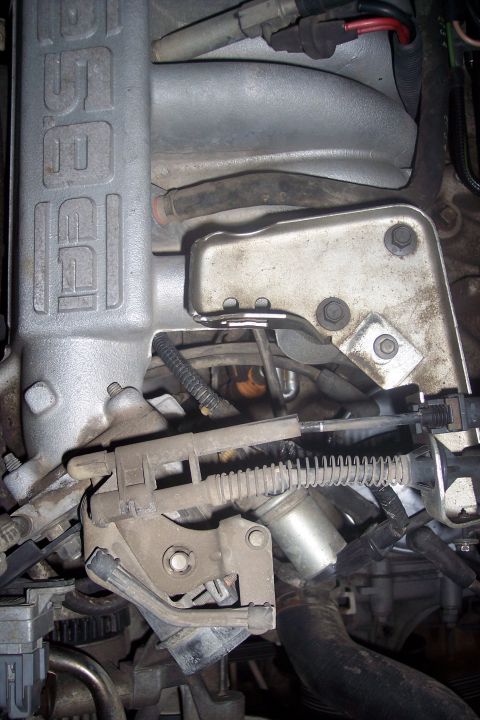1995 Ford Bronco - This close-up image shows the engine bay of a 1995 Ford Bronco, focusing on the intake manifold and throttle body assembly. Various hoses,…