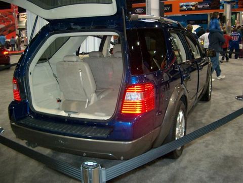 2001 Ford Crown Victoria - A blue SUV is displayed with its tailgate open, showing the cargo area and folded rear seats.