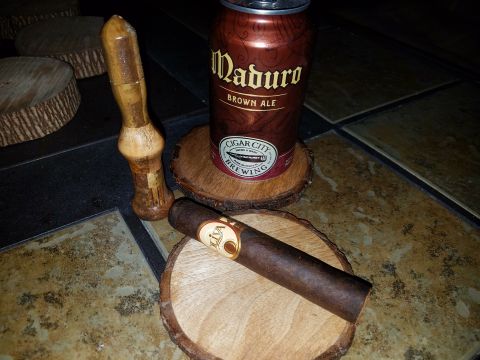 2018 Ford Bronco - A can of Maduro Brown Ale beer sits on a wooden coaster next to a cigar and a wooden tool. Several other wooden coasters are visible in the…