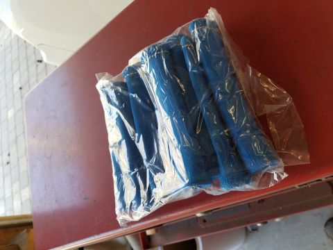 1995 Ford Bronco - A plastic-wrapped bundle of blue mesh-like tubes rests on a red surface.
