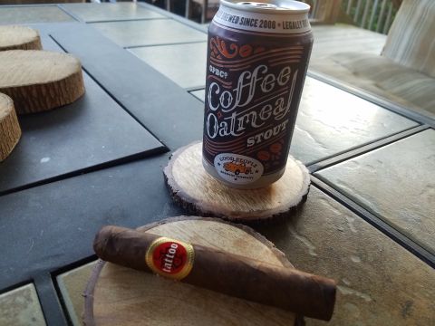2018 Ford Bronco - A can of Coffee Oatmeal Stout beer and a cigar rest on wooden coasters on a tiled outdoor table.