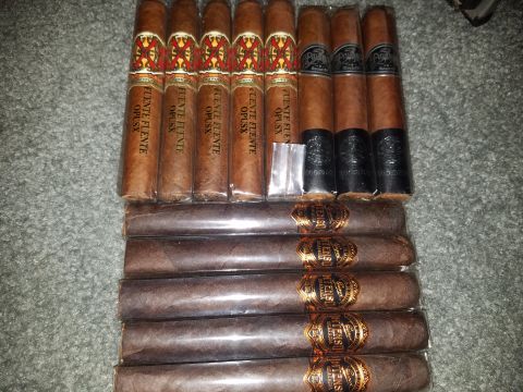 2018 Ford Bronco - A collection of cigars is laid out on a textured surface. The cigars are arranged in two rows, with the top row containing four cigars with…