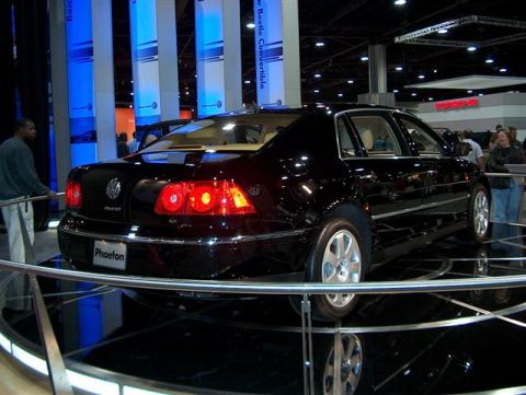 2001 Ford Crown Victoria - A black Volkswagen Phaeton is showcased at an auto show with blue and white banners in the background.