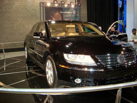 2001 Ford Crown Victoria - A black Volkswagen sedan is displayed indoors with its driver's side door open.