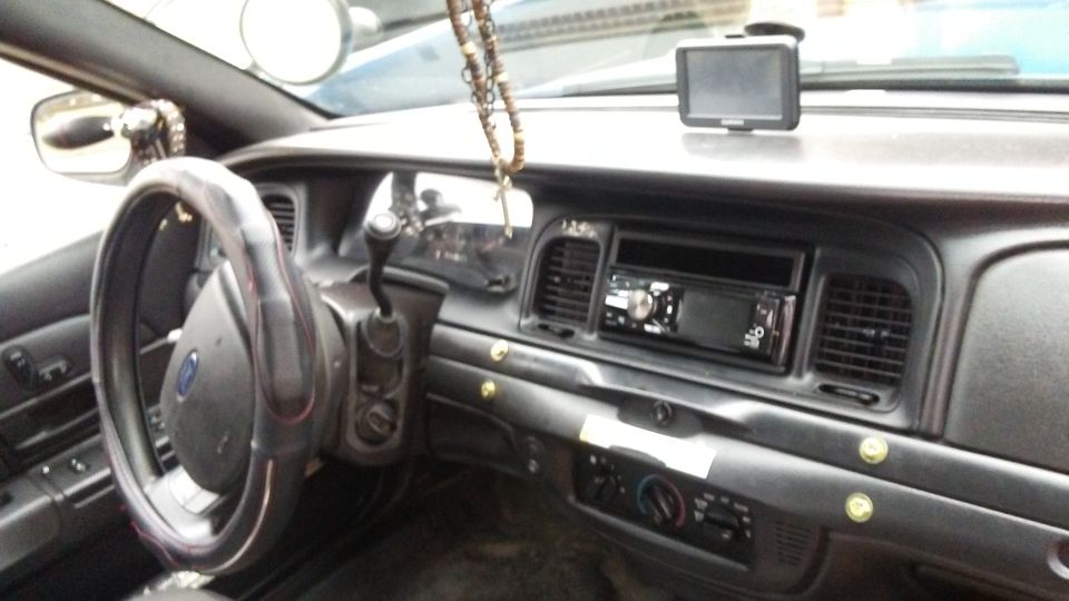 Interior of a 2006 Ford Crown Victoria showing the dashboard, steering wheel, and center console