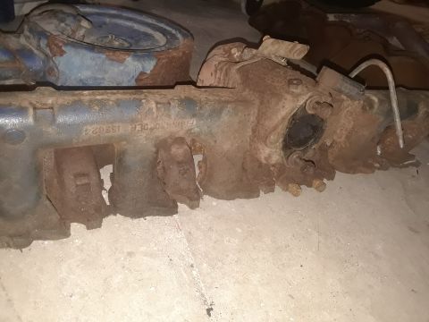 1985 Ford Bronco - Close-up of a rusty engine manifold, showing the part number E5TE 9425 BA.