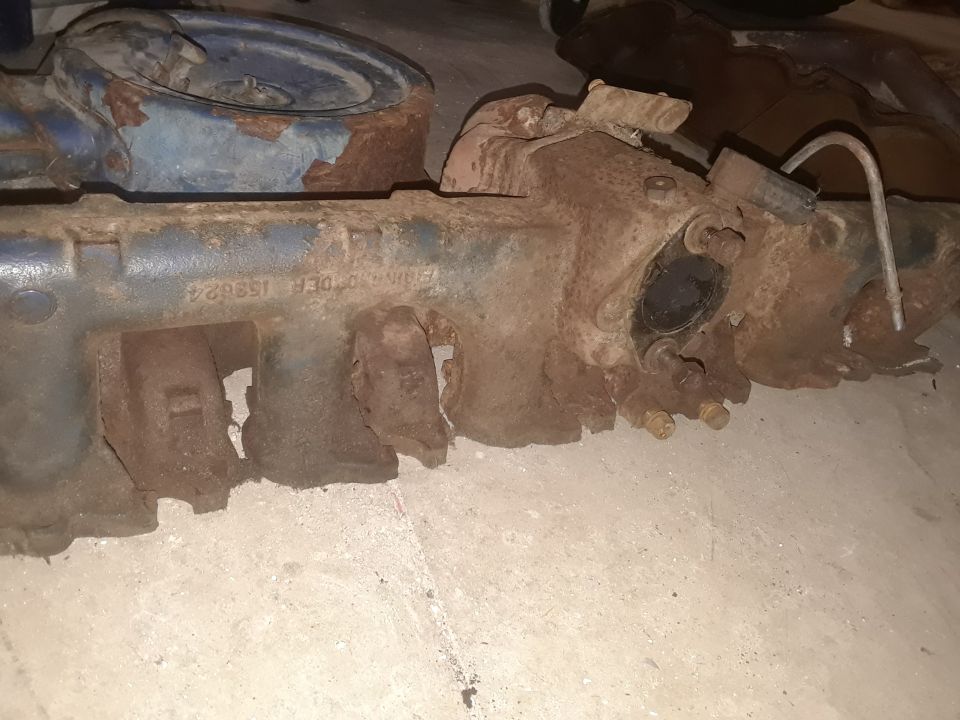 Rusty engine manifold with part number E5TE 9425 BA visible