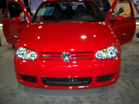 2001 Ford Crown Victoria - A red Volkswagen Golf GTI is displayed with its doors open, showing its interior and front grille.