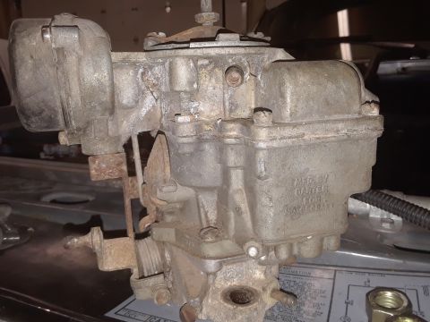 1994 Ford Bronco - A close-up view of a Carter carburetor, showing its mechanical components and some legible text.