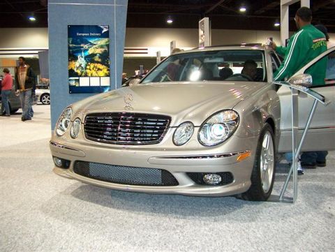 2001 Ford Crown Victoria - A silver Mercedes-Benz sedan is displayed indoors, likely at an auto show.