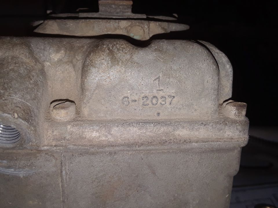 Close-up of a metal part with numbers 1 and 6-2037 stamped on it