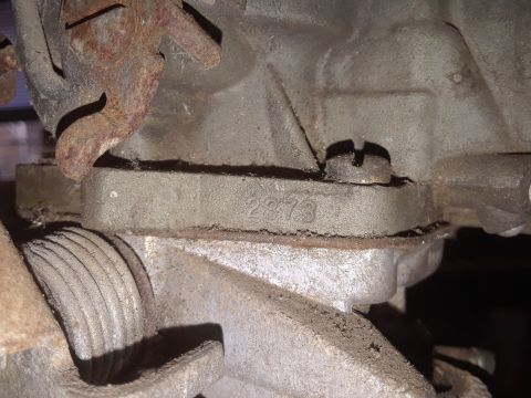 1994 Ford Bronco - A close-up view of a carburetor part shows the casting number 2373 stamped into the metal.