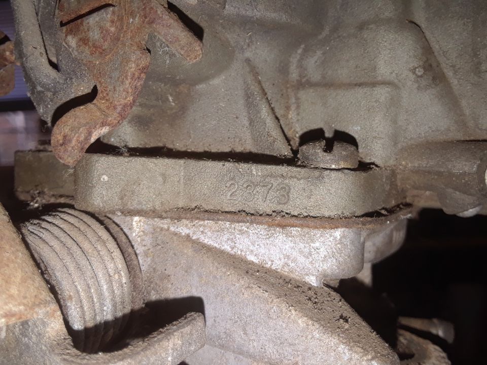 Close-up of carburetor with casting number 2373 visible