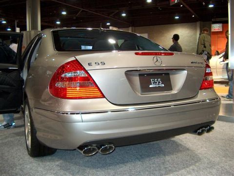 2001 Ford Crown Victoria - Rear view of a silver Mercedes-Benz E55 AMG sedan, identified by its E55 and AMG badging.