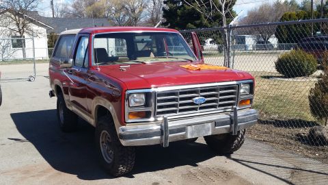 1985 Ford Bronco - This 1985 Ford Bronco is shown in a 3/4 front view, its red paint and white removable top.