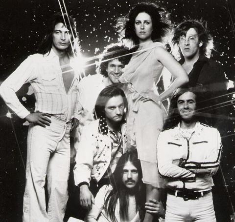 1967 Ford Custom Wagon - A group of musicians with distinctive hairstyles and clothing pose for a promotional photograph.