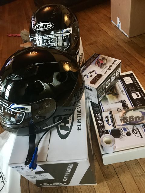 1988 Ford Bronco - Motorcycle helmets and various accessories are laid out on a wooden floor.