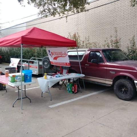 1996 Ford Bronco - A 1996 Ford Bronco is parked at an outdoor event with tables set up under a red tent.