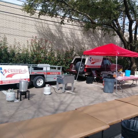 1996 Ford Bronco - A red Ford Bronco is parked at an outdoor event with a U-Haul trailer and crawfish cooking equipment.
