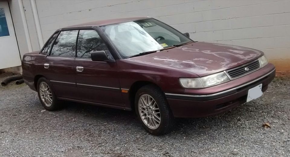 Maroon 1994 Subaru Legacy sedan, 3/4 front view