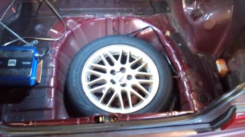 1994 Subaru Legacy - The spare tire and amplifier are visible in the trunk of the car.