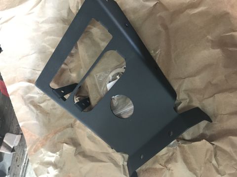 1988 Ford Bronco - A black metal bracket is shown against a background of brown paper packaging.