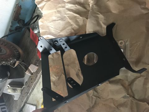 1988 Ford Bronco - A black metal automotive part, possibly a skid plate, is shown with protective paper wrapping and a SuperMotors logo visible.