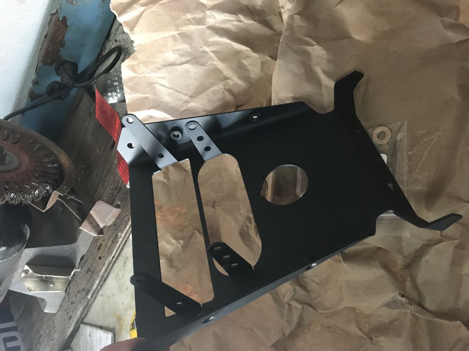 Black metal part with paper wrapping and SuperMotors logo