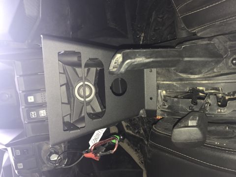 1988 Ford Bronco - Close-up of an interior vehicle part, possibly an aftermarket accessory, with a fan and carabiner attached.
