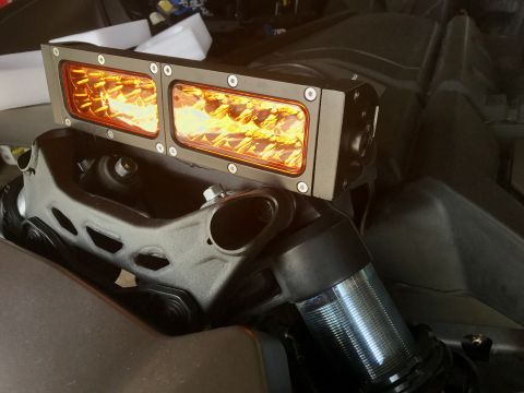 1988 Ford Bronco - Close-up of an aftermarket light bar installed on a vehicle's suspension system.