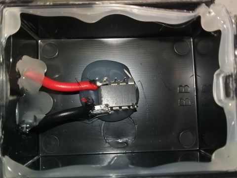 1993 Ford Bronco - Close-up of an electrical component with visible wiring and sealant inside a black housing.