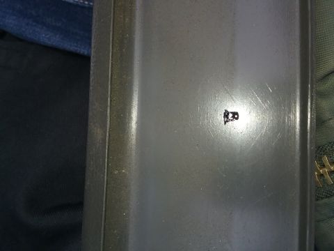 1993 Ford Bronco - A close-up view of a small black emblem on a textured gray surface.