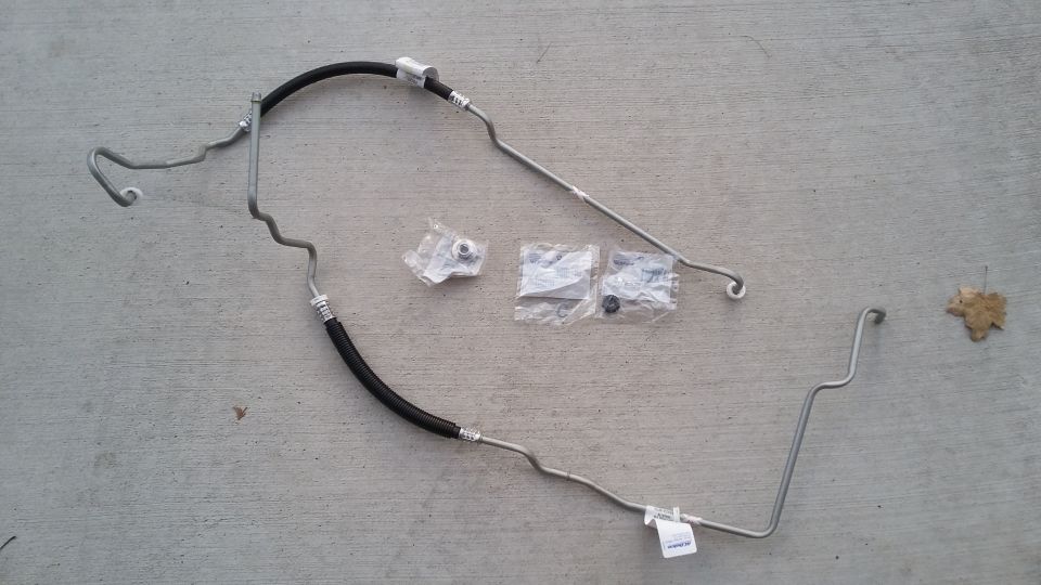 Power steering hose assembly with fittings on concrete